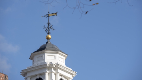 The spire on the top of Old Queens in fall