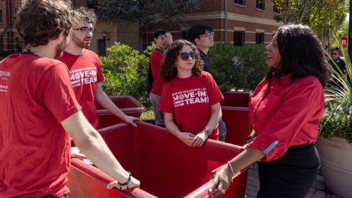 Rutgers-New Brunswick Chancellor Francine Conway (right) speaks with student members of the Residence Life move-in team Monday outside BEST Hall.