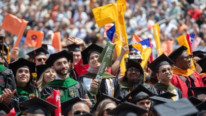 A crowd of graduates in caps and gowns at commencement