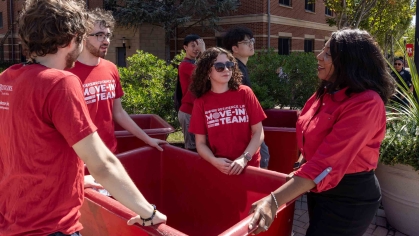 Rutgers-New Brunswick Chancellor Francine Conway (right) speaks with student members of the Residence Life move-in team Monday outside BEST Hall.