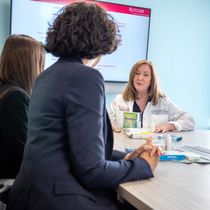 Researchers at the Center for Tobacco Studies talk around a conference table