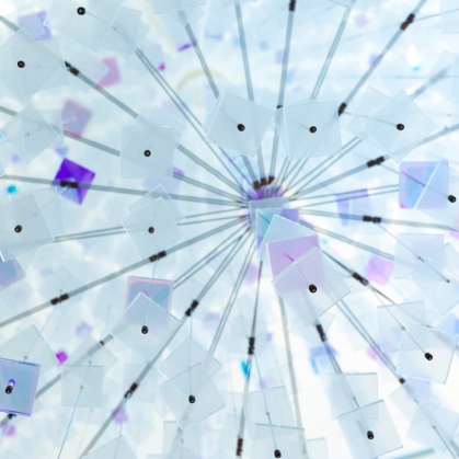 Tiny square blue tiles hang from a ceiling sculpture called Helix