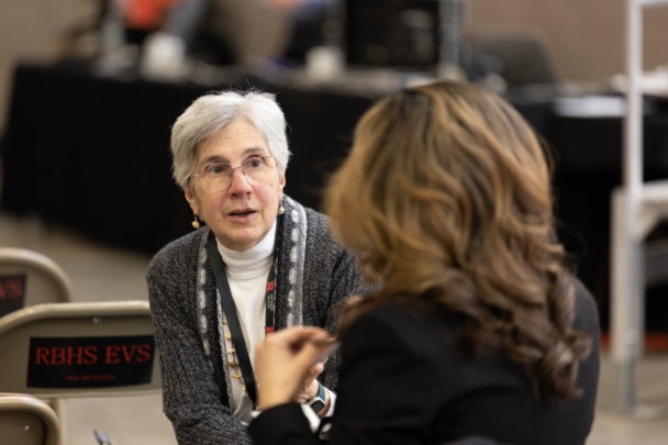 Attendees talk in groups at the integration summit.