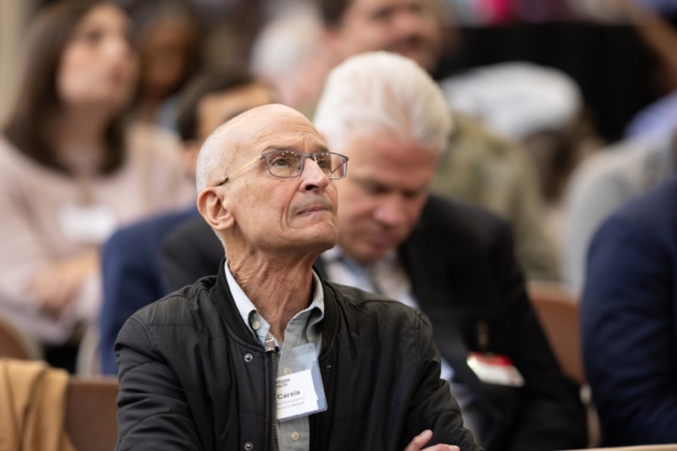 Attendees listen to a speaker presentation at the integration summit.