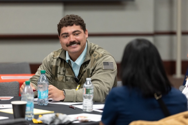 Attendees talk in groups at the integration summit.