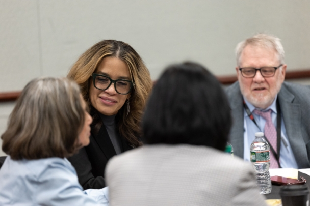 Attendees talk in groups at the integration summit.