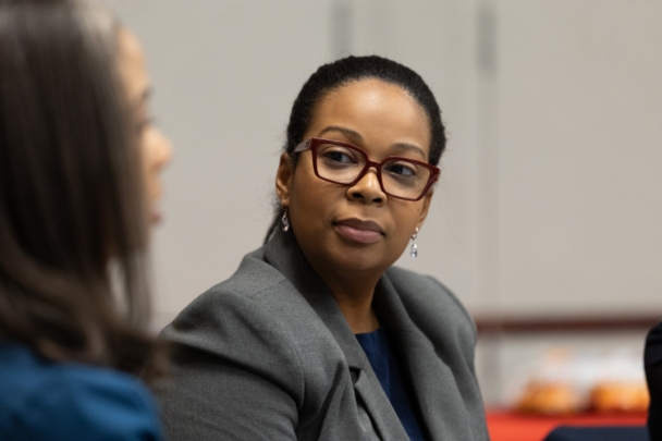 Attendees talk in groups at the integration summit.